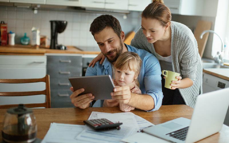 family at table looking at tablet