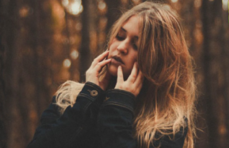 girl holding her jaw in pain from oral surgery