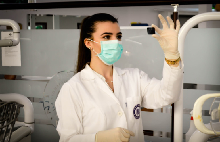 dental hygienist examining an x-ray