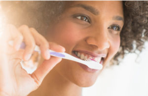 girl brushing her teeth to keep them white