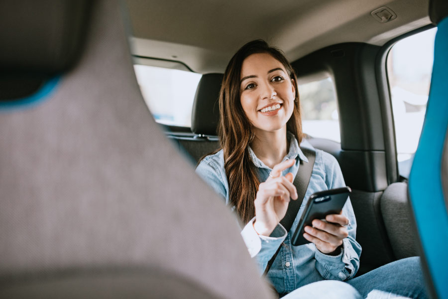 young woman remains in her car when visiting the dentist until called in for the appointment