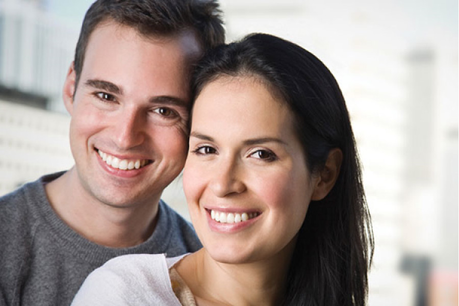 young couple smile together showing off results from cosmetic dentistry