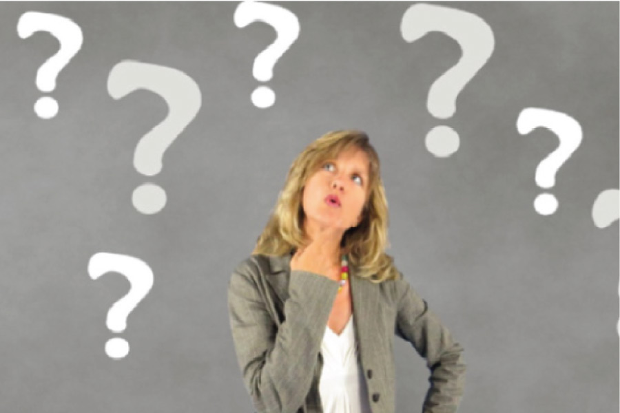 woman surrounded by question marks ponders dental implants