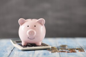 piggy bank on calculator, dental insurance or dental membership plan