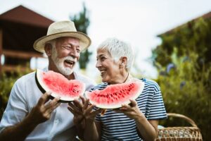 couple smiling eating summer foods for teeth like watermelon