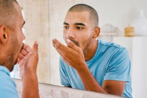 man checking if he has bad breath from a cavity