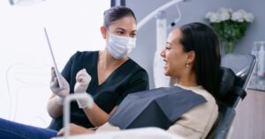 discussing custom treatment plan with patient at dentist