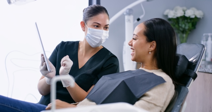 discussing custom treatment plan with patient at dentist